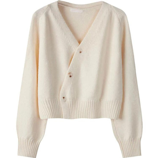 Alora trui in een moderne off-white kleur met asymmetrische knoopsluiting. De trui heeft een comfortabele pasvorm, lange mouwen en een brede ribgebreide taille. Perfect voor een stijlvolle en eigentijdse look.