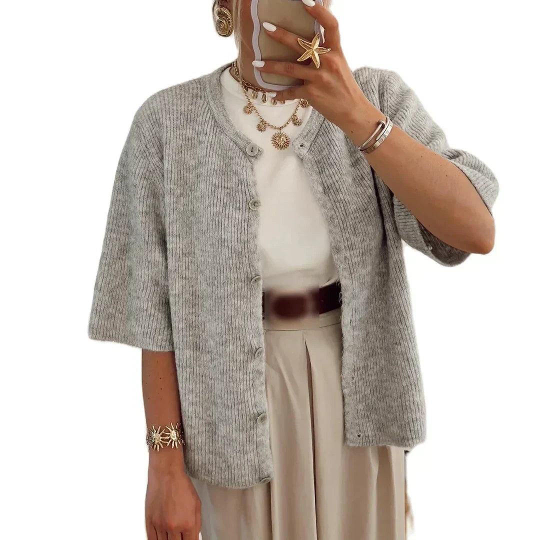 Bellorra vrouwelijk gilet in lichtgrijs, met een klassieke knoopsluiting en korte mouwen. Dit tijdloze gilet is ideaal voor een elegante en moeiteloos stijlvolle look. Perfect te combineren met een witte top en beige broek voor een verfijnde uitstraling.