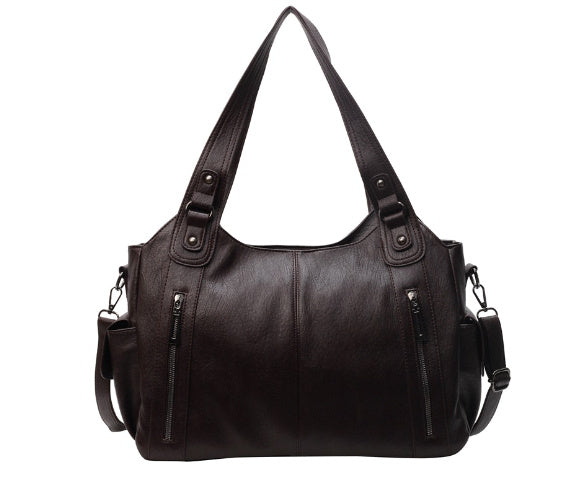 Kaldar stijlvolle leren tas in zwart, met een elegant design en dubbele handvatten. De tas heeft voorvakken met ritssluitingen en een afneembare schouderriem, wat zorgt voor veelzijdigheid en praktische opbergruimte. Perfect voor dagelijks gebruik met een tijdloze uitstraling.