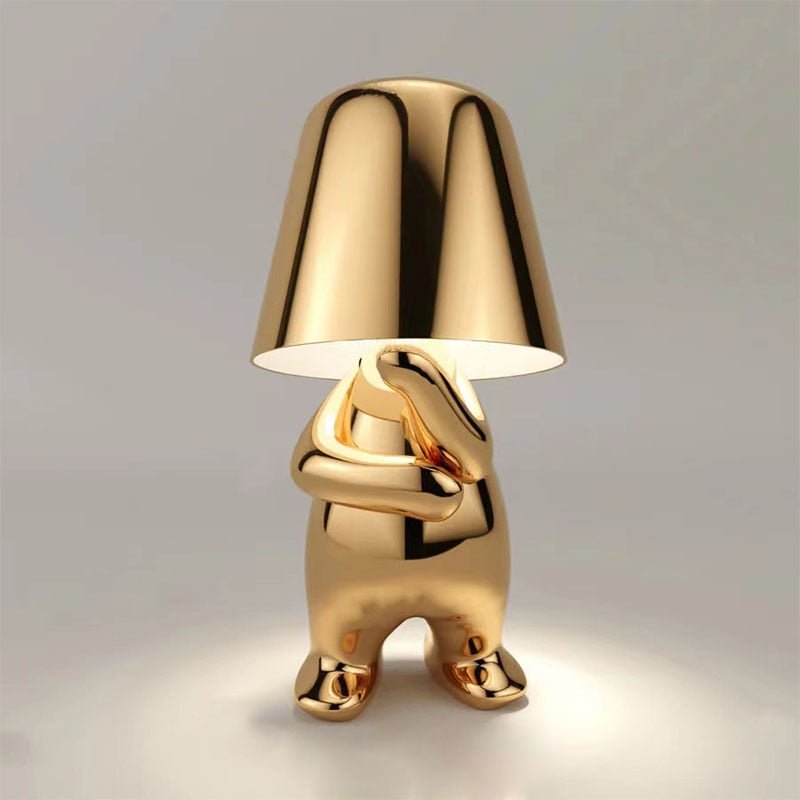Unieke gouden Lumineer tafellamp met een modern en speels ontwerp, ideaal voor flexibele verlichting en een stijlvol accent in uw interieur.
