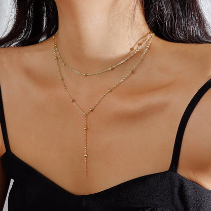 Ketting met Fijne Bolletjes en Elegante Hangende Oorbellen